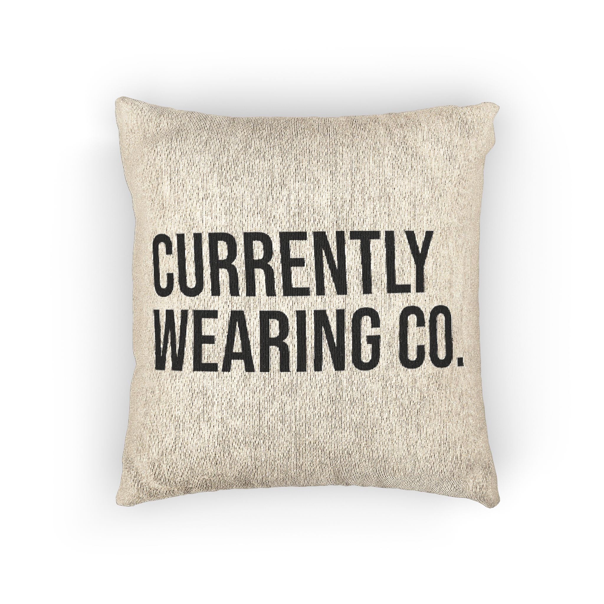 Beige pillow with black text 'CURRENTLY WEARING CO.' on a white background
