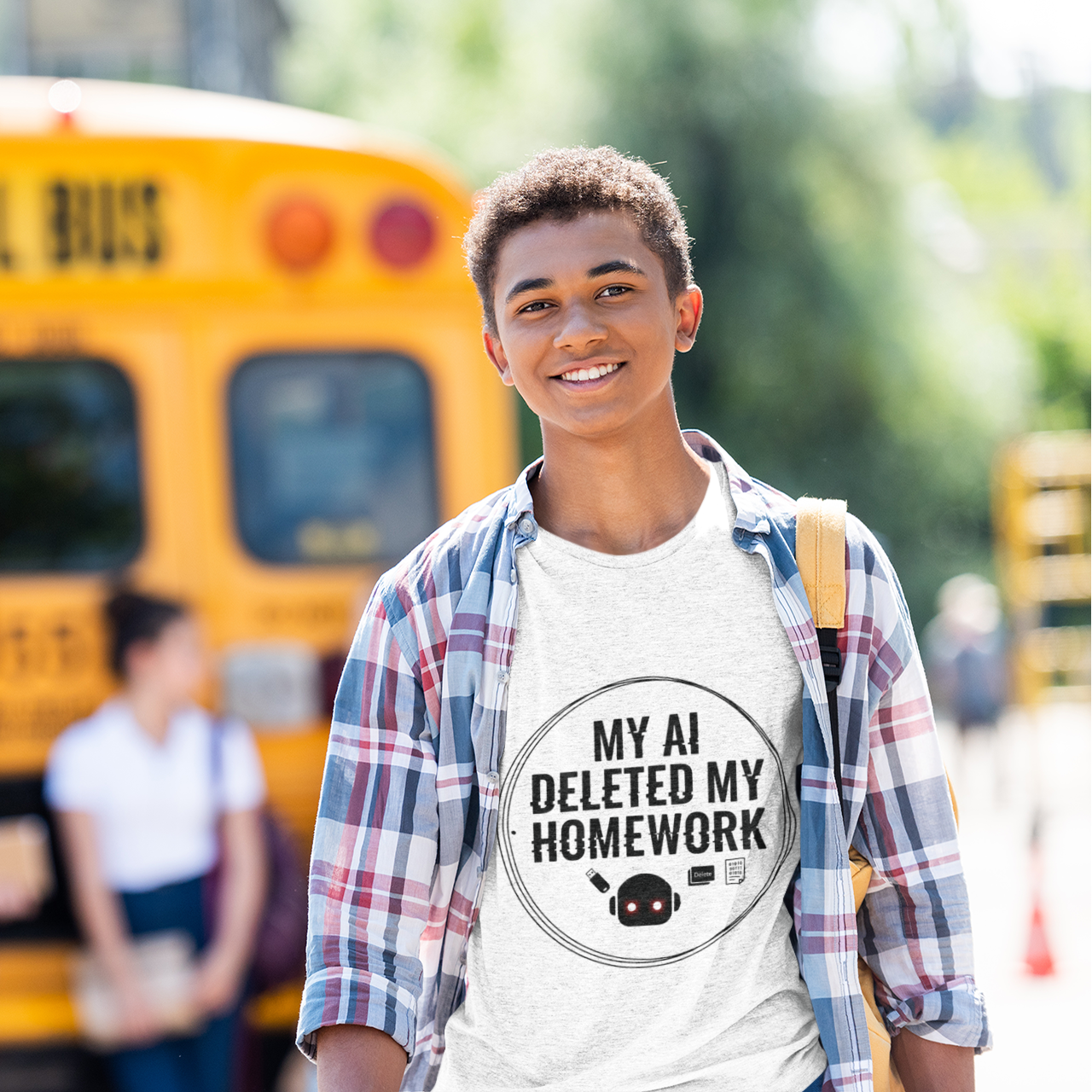 Person wearing a shirt with 'My AI deleted my homework' text in front of a school bus.